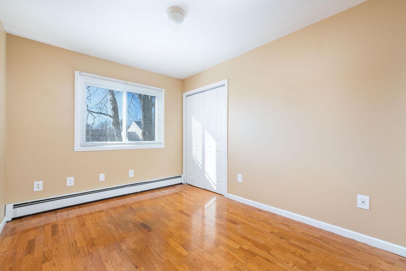 3rd bedroom with refinished hardwood floors and baseboard heat